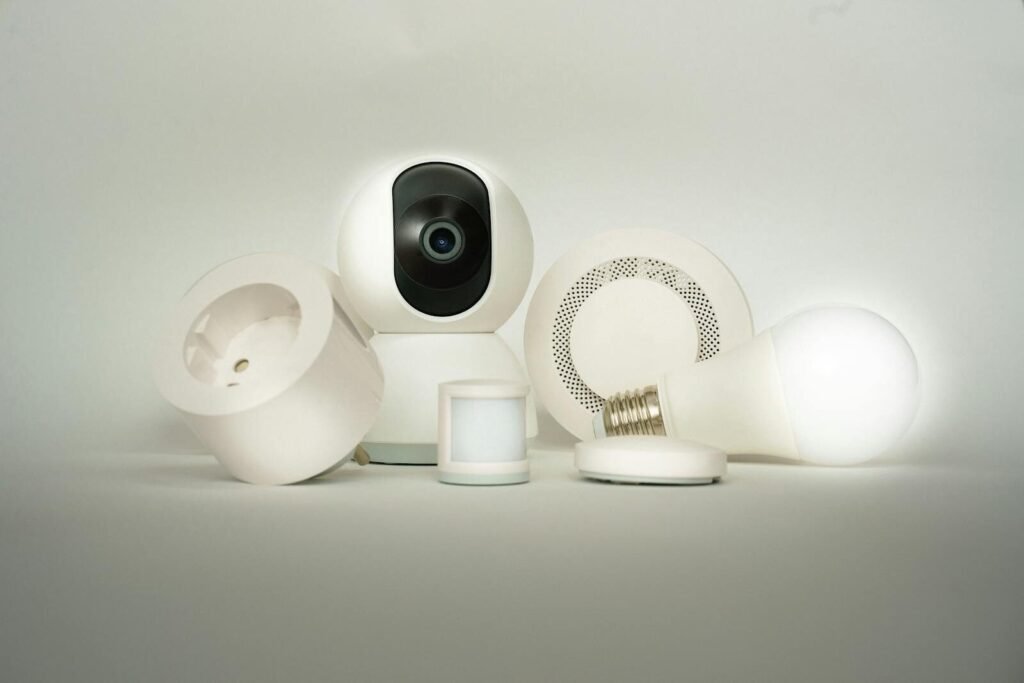 A collection of smart home devices, including a camera, light bulb, and sensors, on display.