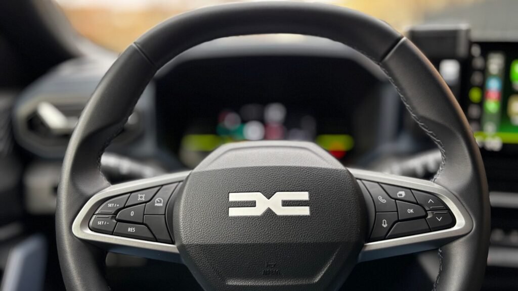 A steering wheel with the dacia logo.